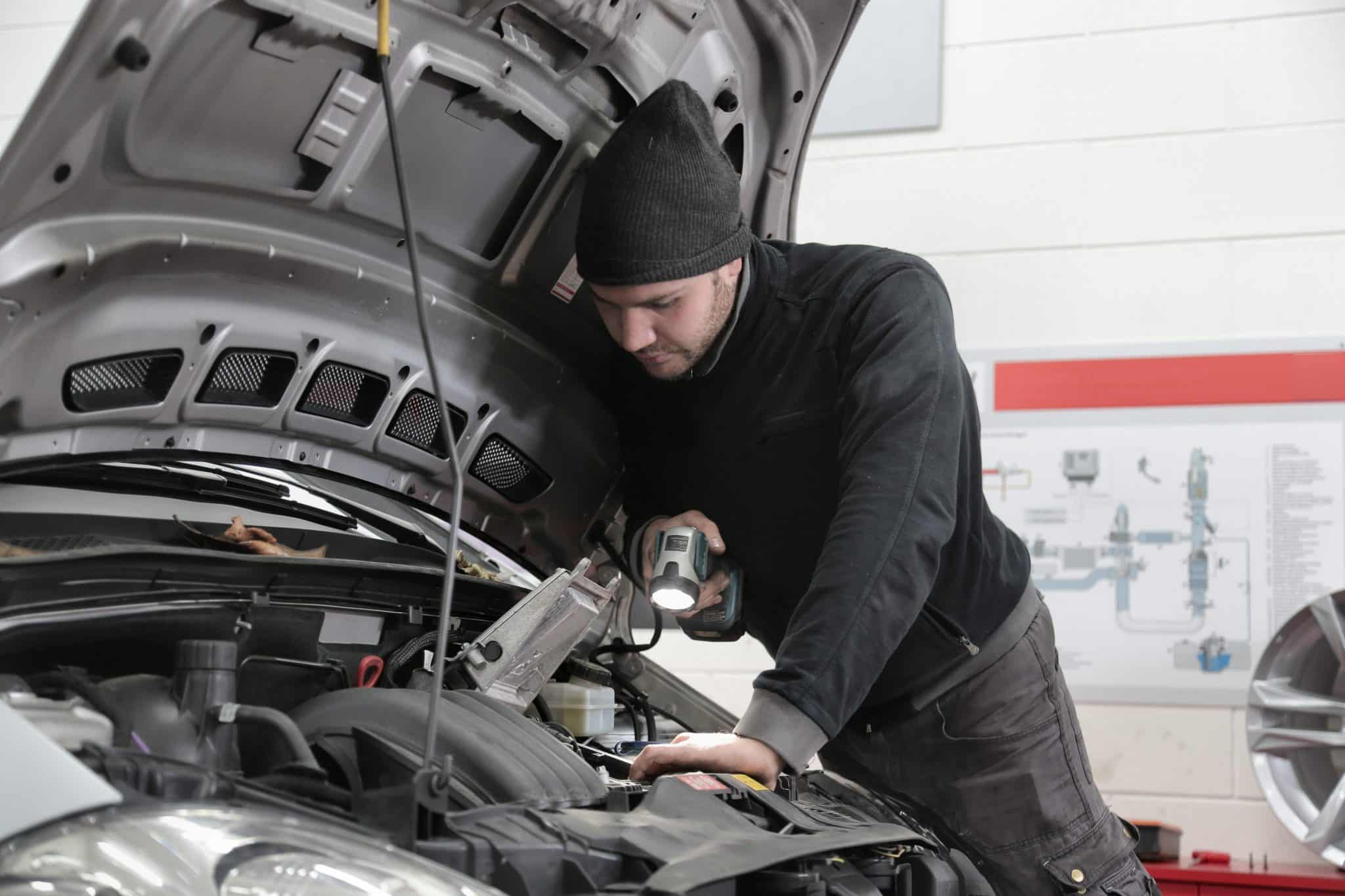 An Autobahn technician examining a car during a car diagnostic test